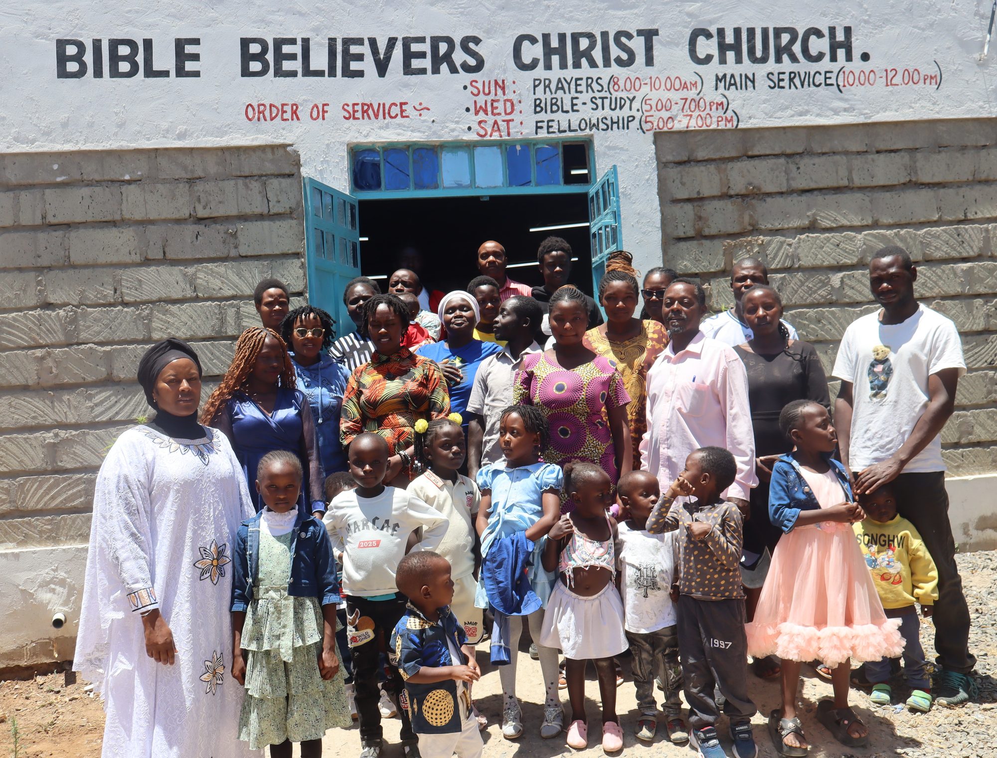 Members and children outside the BBCC church building